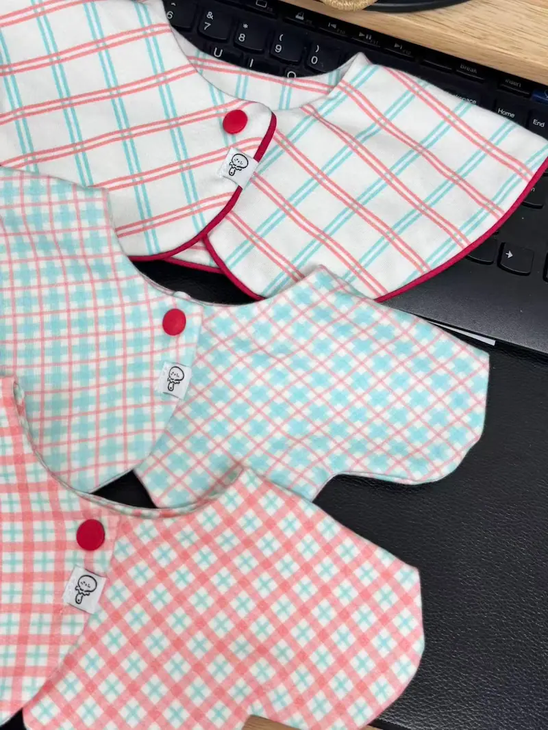 Sophisticated handcrafted 100% combed cotton defines these best baby bibs. Featuring soft, festive lattices and gingham motifs, these pure handmade bibs for baby offer unrivaled softness, rapid absorbency, and guaranteed 2026 OEKO-TEX & GOTS safety.