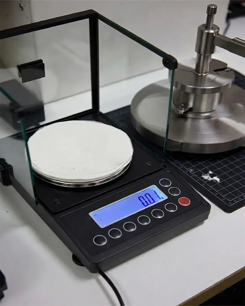 This industrial swatch test demonstrates the exact measurement of textile density. Accurate weight data is essential for maintaining product consistency and meeting professional B2B sourcing criteria.