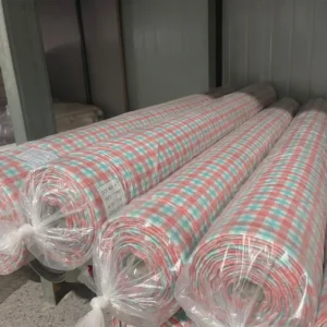 Rolled fabric storage showcasing organized production inventory of reactive dye-printed muslin materials. Protective wrapping ensures material preservation. Professional OEM/ODM manufacturing from Chinese B2B baby textile factory.