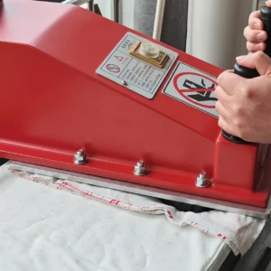 Precision Die-Cutting Process advances with hydraulic cutting machine positioning above fixed metal dies. Advanced pressure control system ensures optimal cutting force. Professional OEM/ODM manufacturing from Chinese B2B baby textile factory.