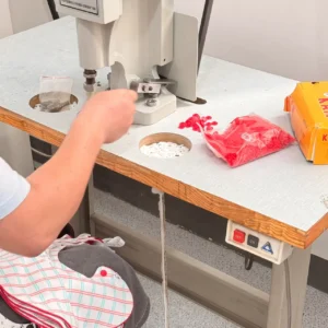 Snap Fastening Process utilizes advanced pneumatic snap machines for high-volume production ensuring consistent pull strength. Industrial automation applies snaps through fabric with precision. OEM/ODM manufacturing from professional Chinese B2B baby textile factory.