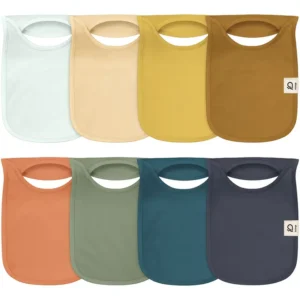 Featured tones include Arctic White, Sun Yellow, Mustard, Bronze, Terracotta, Forest Green, Petrol Blue, and Charcoal. These highly absorbent 100% cotton bibs for baby are purely handcrafted for silky softness. Specialized OEM, ODM, and Customized services are guaranteed to pass GOTS and OEKO-TEX.