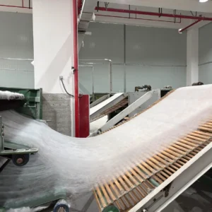 Carding and Lapping Process culminates in reciprocating cross-lapper creating systematically layered fiber structure. Precision speed and angle calibration control mattress core thickness and density. OEM/ODM manufacturing from professional Chinese B2B baby product factory.