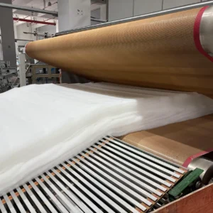 Our technical setup feeds the prepared fiber matrix directly into a full-penetration hot air circulation oven for three-dimensional thermal welding. This robust and stable thermal circulation system ensures that low-melting-point components melt uniformly at every contact point, permanently locking the structure into form.