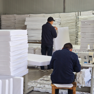 Our manufacturing facility integrates a dedicated assembly workshop where finished covers are meticulously fitted onto our hot-air-bonded mattress cores. Our skilled production personnel execute continuous physical cross-checks on corner alignment, surface flatness, and edge verticality to ensure high-efficiency standardized delivery.