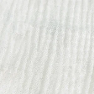 Our specialized multi-layer weaving process creates a lightweight, crinkled texture that enhances the overall loft and breathability of the fabric. Our baby textile factory in China avoids heavy mechanical compression during production, ensuring the textile retains its signature airy softness and delicate tactile appeal.