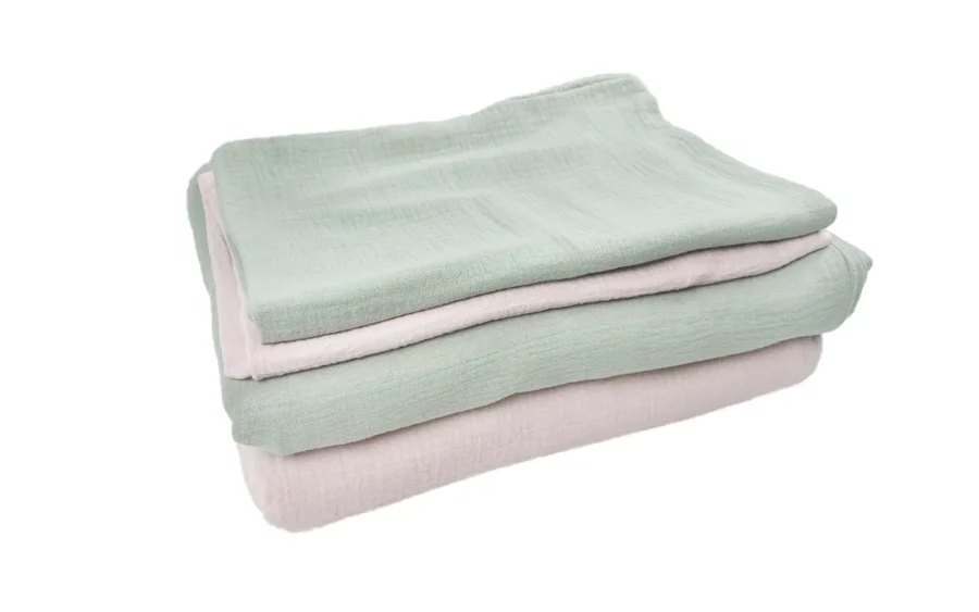 Muslin cotton two-color two-piece set angled view display showcases soft blush pink and sage green side-by-side. Without pillow and quilt cores multi-perspective display of product design and color matching. We provide professional OEM customization supporting multi-color combination, size customization, and comprehensive optimization comprehensive services.