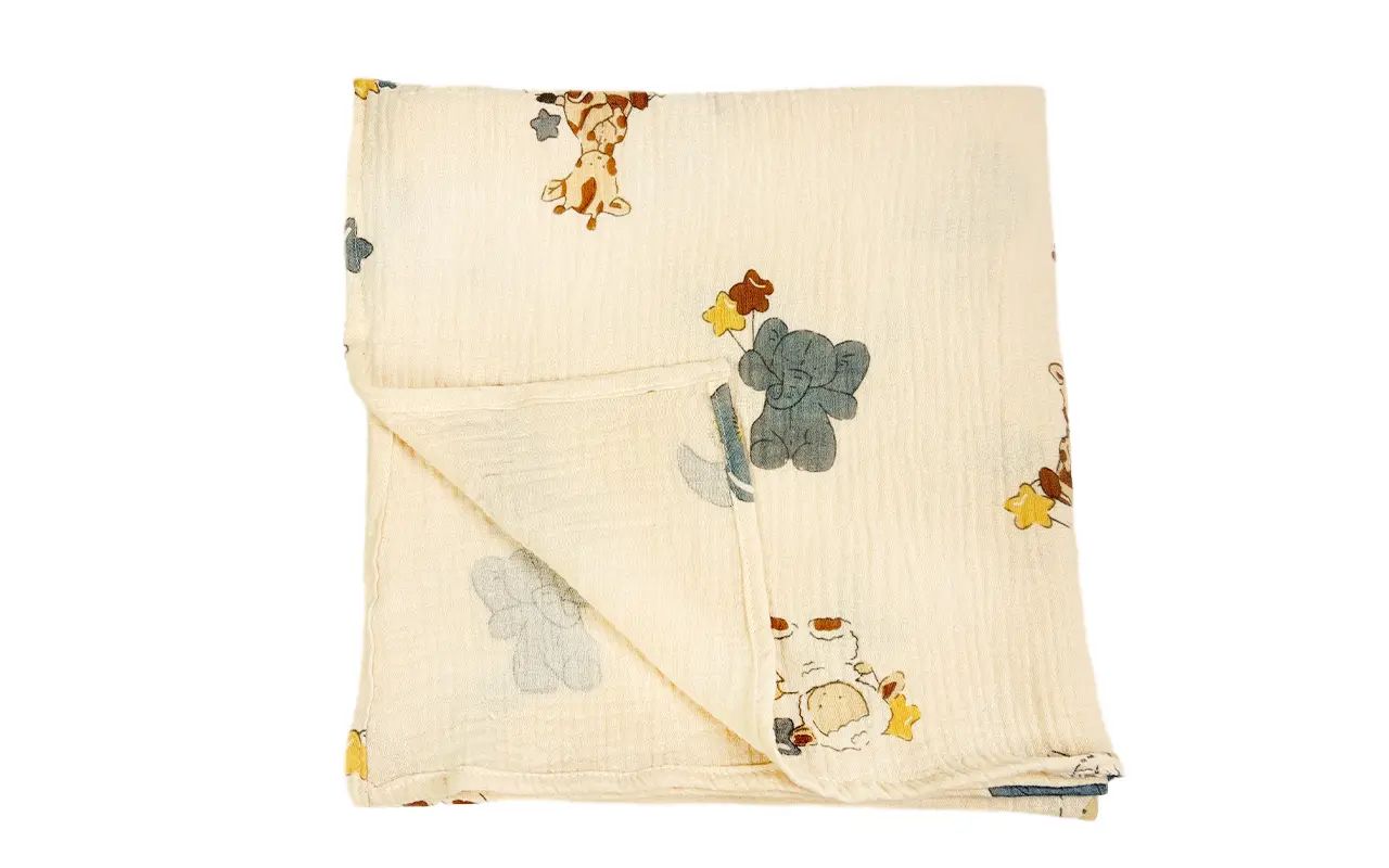 Neatly folded Forest Friends muslin cotton blanket reveals complete size, premium fabric quality, and balanced woodland animal print distribution. Versatile multi-use design. OEM/ODM wholesale solutions from professional Chinese B2B textile factory.