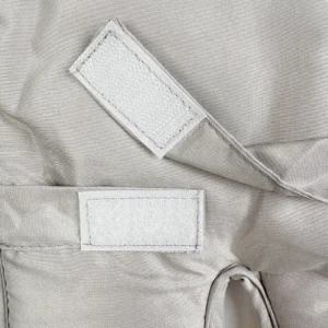Our finished infant high-chair cushion showcases the perfectly aligned dual Velcro strap system positioned adjacent to a heavily reinforced safety harness slot. As an established baby textile factory in China, we prioritize structural aesthetics and absolute durability in our finished fastening components.