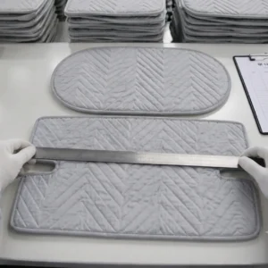 Our finished infant seat cushion liners undergo strict dimensional audit testing on specialized evaluation tables to cross-reference perimeter parameters against the original blueprint specs. Operating as a professional baby textile factory in China, we apply these rigorous measurement routines to maintain zero-variance structural sizing across massive B2B production runs.