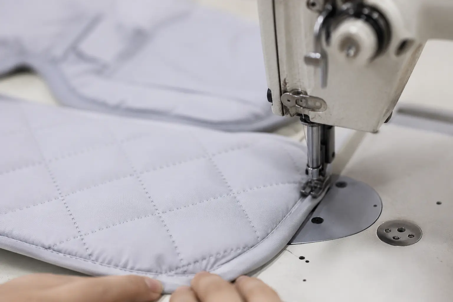 Close-up of precision quilted stitching demonstrates expert baby seat cushion manufacturing craftsmanship. Advanced sewing technology ensures durable, secure construction. OEM/ODM manufacturing solutions from professional Chinese B2B baby textile factory.