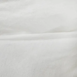 Our internal edge-processing replaces harsh mechanical embossing with smooth, flat-seam structures to completely avoid friction against an infant’s delicate skin. As an advanced baby textile factory in China, we prioritize flat, burr-free stitch lines to maintain ultimate interior garment comfort.