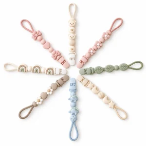 Our silicone baby pacifier clips form a radial display with even lengths, loops, PU plastic clips, and bear, flower, leaf, moon, dinosaur, heart, rainbow, and bow motifs. Inorange Baby offers OEM/ODM.