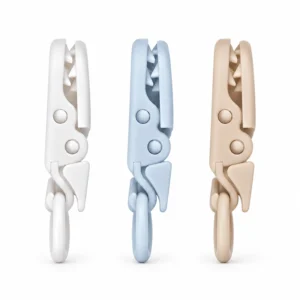 Our PU plastic pacifier clips show three colors with gripping teeth, pivots, and silicone loops, supporting secure fastening across custom silicone pacifier clip designs. Inorange Baby offers OEM/ODM.