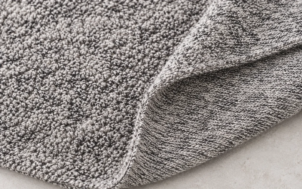 We reveal the two surfaces of marled knitted terry: a rich looped face for absorbency and a flatter knitted reverse for layering, flexibility, and controlled placement in custom baby textile products.